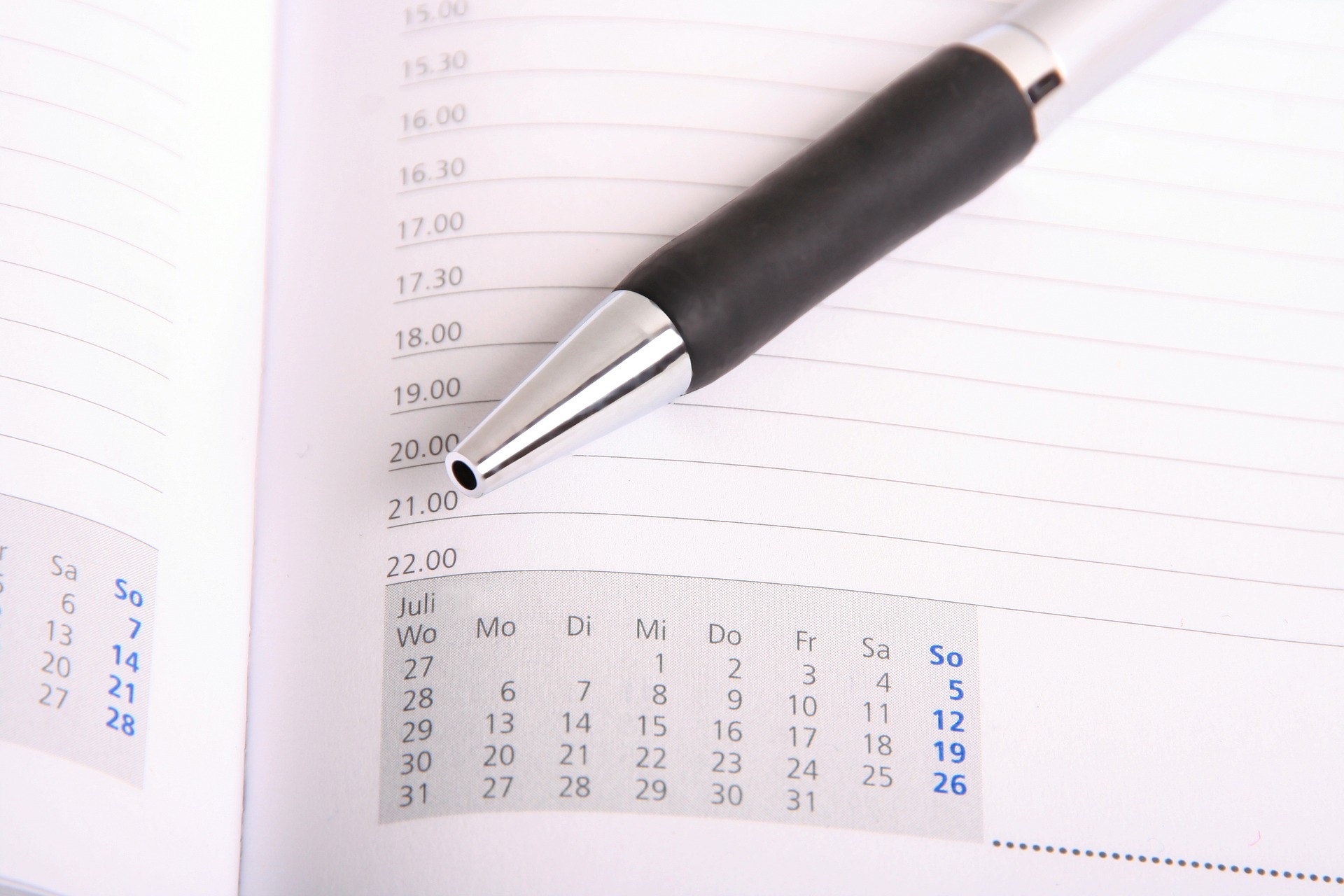 page of an hourly planner and a pen for setting remote schedule more efficiently