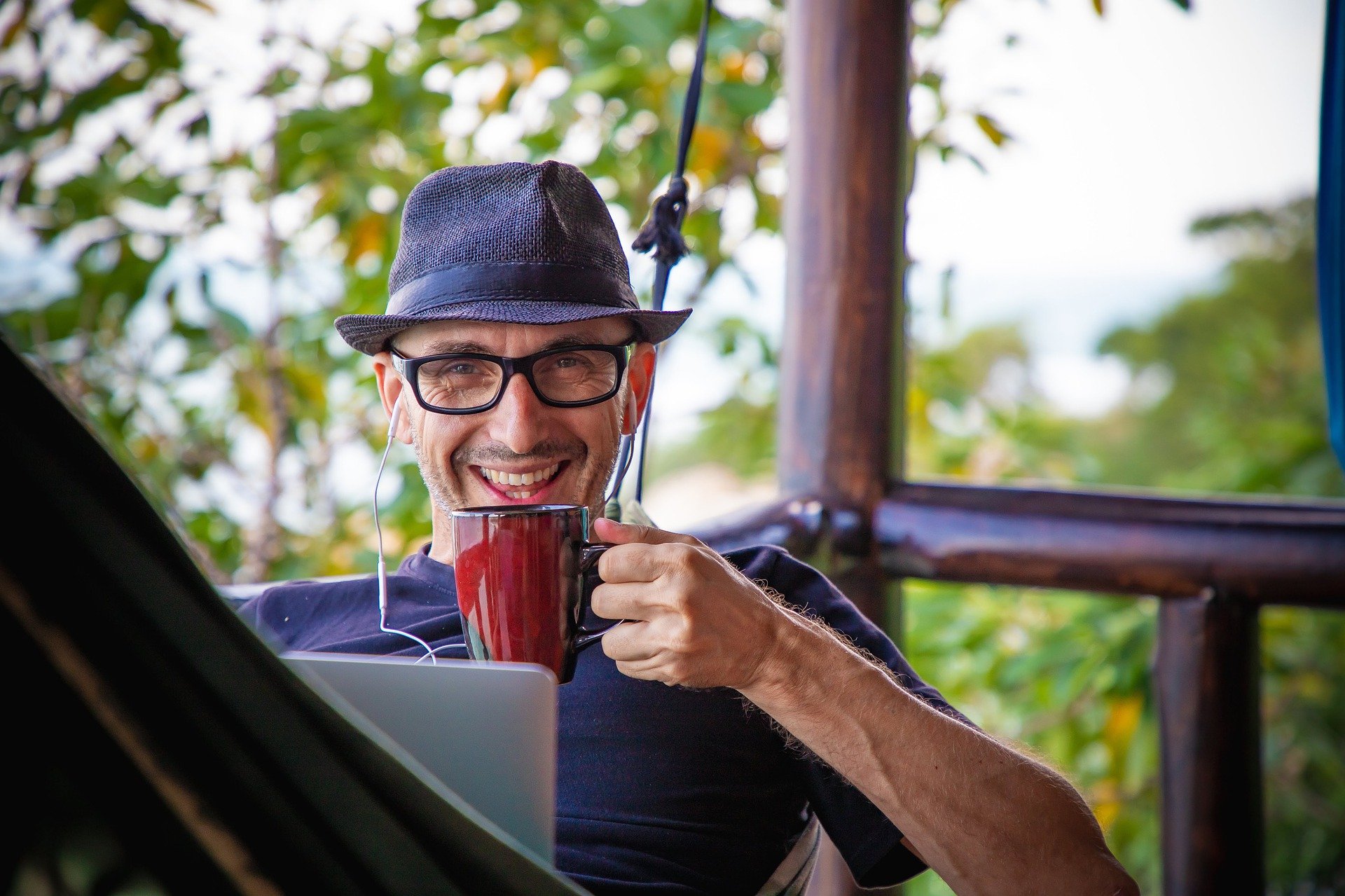 man drinking coffee while remotely working